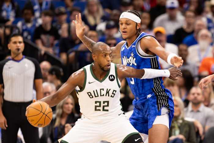 Milwaukee Bucks forward Khris Middleton (22) pushes past Orlando Magic forward Paolo Banchero (5)